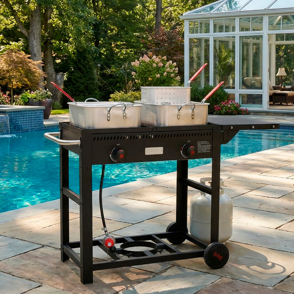 Portable propane grill with pots on a patio near a pool